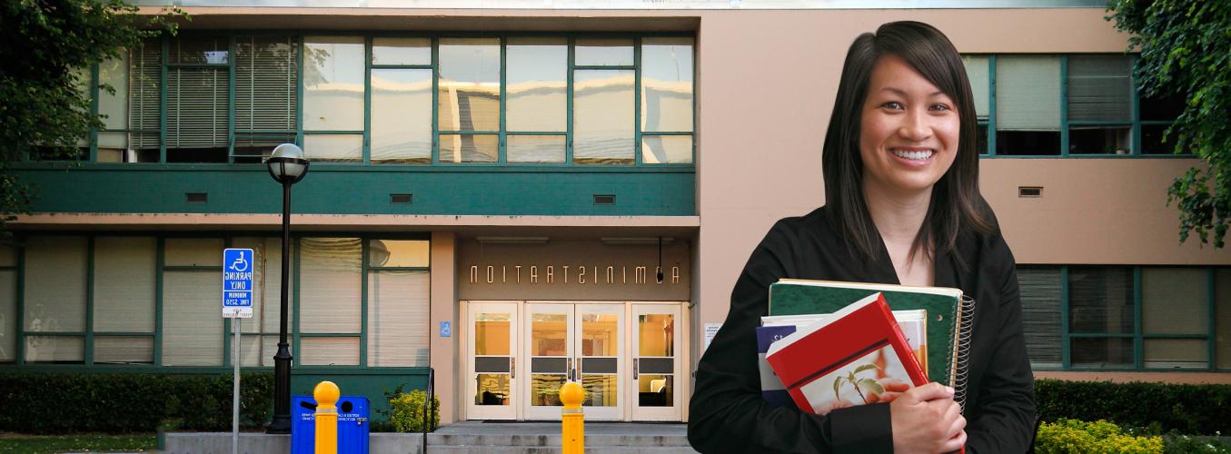 Student standing in front of Admin Building.